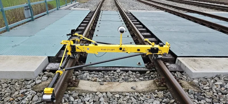 Measuring across a level crossing and into the switch behind it; the frame folds for transport in a car