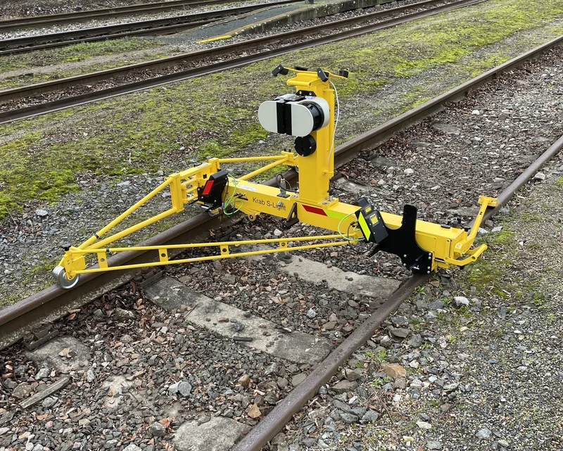 Close view of the winter set-up: SICK scanner and track camera on the mast, optional rail profile cameras fitted over both rails at the front of the trolley