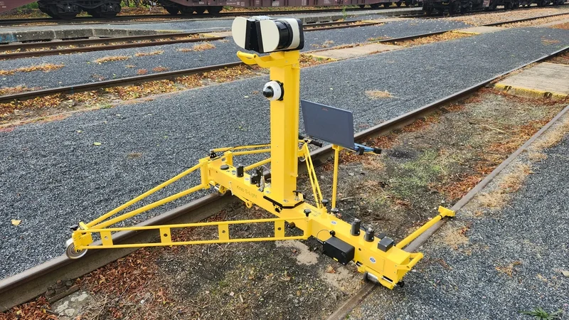 LPS on a KRAB S-LIGHT in a rail yard: the SICK laser scanner on top of the mast, the track camera below it, the tablet running Krab OnBoard on the holder