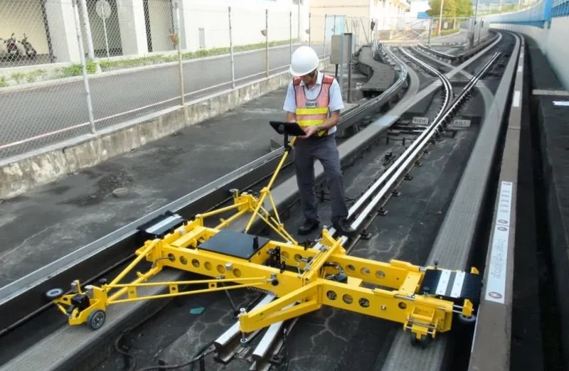 The RWT built for Taipei Metro (TRTC), in service since 2010, at a switch of the rubber-tyred line; the operator follows the measurement on a tablet