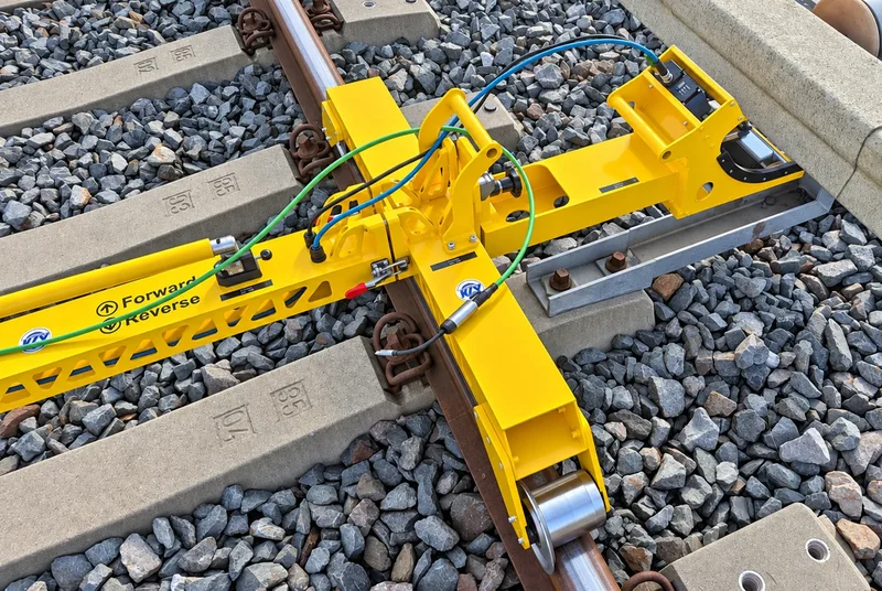 The add-on on a yard track with a length of conductor rail mounted on brackets beside the running rail